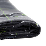 A folded grey beach towel featuring a patterned design with green accents and a logo.