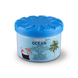 A round, blue container of air freshener named "Ocean" featuring a tropical drink design on the lid.