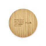 A round, bamboo wireless charger featuring engraved specifications on the surface and a simple, natural design.