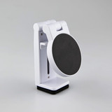 A white mobile phone stand with a black circular holder, featuring a sleek and compact design.
