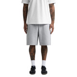 Grey track shorts with an elastic waistband, featuring a relaxed fit and a logo. Worn with a white t-shirt and dark shoes.
