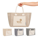 A striped tote bag in beige and brown, featuring a pocket and branding, with black and navy versions displayed below.