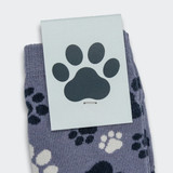 Jolly knitted kids socks in grey with a playful paw print pattern, featuring a branded tag.