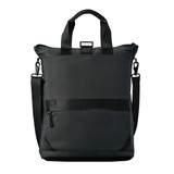 A dark-coloured tote backpack with dual carry handles and a shoulder strap, featuring a zipper and pockets. A dark-coloured tote backpack with dual carry handles and a shoulder strap, featuring a zipper and pockets.