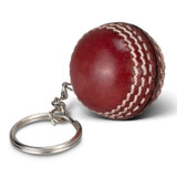 A red cricket ball key ring featuring white stitching and a metal keychain attachment. A red cricket ball key ring featuring white stitching and a metal keychain attachment.