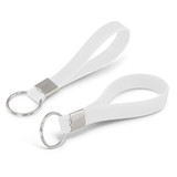 A white silicone key ring with a debossed design and a metal ring attachment. A white silicone key ring with a debossed design and a metal ring attachment.