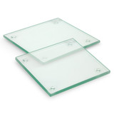 A set of two square glass coasters with a clear finish and rounded corners, featuring small rubber feet on the bottom. A set of two square glass coasters with a clear finish and rounded corners, featuring small rubber feet on the bottom.
