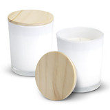 Two white glass candles with wooden lids placed beside each other. One lid is off, revealing the candle inside. Two white glass candles with wooden lids placed beside each other. One lid is off, revealing the candle inside.