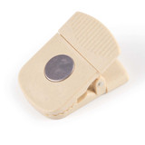 A beige Croc Magnetic Clip featuring a circular metallic element and a textured grip for easy handling. A beige Croc Magnetic Clip featuring a circular metallic element and a textured grip for easy handling.