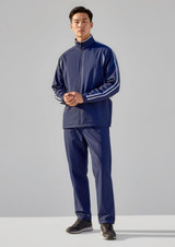 A model wearing unisex navy track pants paired with a matching zip-up jacket featuring white stripes.