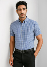 A short-sleeve button-up shirt in navy and white checkered pattern, featuring a collar and a logo.