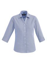 A women's button-up shirt in light blue, featuring a 3/4 sleeve design and a collar. It has a logo on the label.