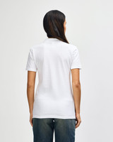 A white ladies' double pique polo shirt with a collar, viewed from the back. It has a logo on the side.