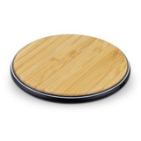 A round, bamboo wireless fast charger with a sleek black base. A round, bamboo wireless fast charger with a sleek black base.