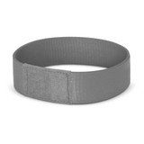 A grey wristband with a smooth finish and a woven texture, featuring a section for secure fastening.