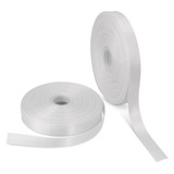 Two rolls of 25mm wide personalised ribbon in white, one partially unrolled. One roll has a logo. Two rolls of 25mm wide personalised ribbon in white, one partially unrolled. One roll has a logo.