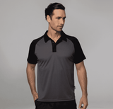 A man is wearing a grey and black polo shirt, featuring a collar and short sleeves. The shirt has a logo. A man is wearing a grey and black polo shirt, featuring a collar and short sleeves. The shirt has a logo.