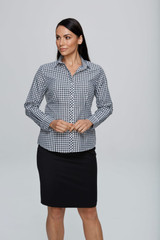 A long sleeve button-up shirt featuring a black and white check pattern, paired with a black skirt.