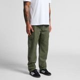 Utility cargo pants in olive green, featuring multiple pockets, worn by a person in a white t-shirt and black sneakers.