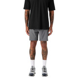 Active shorts in grey, paired with a black shirt and athletic shoes, featuring a logo on the shorts.