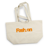A cream tote bag with long handles and an orange logo. Features a spacious design for carrying items.