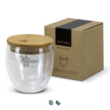 A glass cup with a bamboo lid, featuring a design on the front, beside its cardboard packaging. A glass cup with a bamboo lid, featuring a design on the front, beside its cardboard packaging.