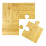 A bamboo coaster set featuring four interlocking puzzle pieces in a natural finish. A bamboo coaster set featuring four interlocking puzzle pieces in a natural finish.