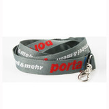 A grey woven lanyard with red and silver branding, featuring a metal clip for attachment. A grey woven lanyard with red and silver branding, featuring a metal clip for attachment.