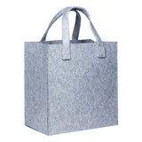 A grey felt tote bag with sturdy handles, featuring a simple and minimalist design. It has a logo on one side.
