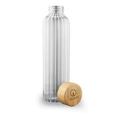 A drink bottle made of clear glass with a ribbed design, featuring a wooden cap and a logo.
