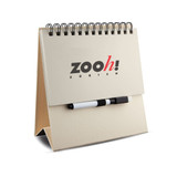A white memo whiteboard notepad with a spiral binding and a black marker, featuring a logo on the front.