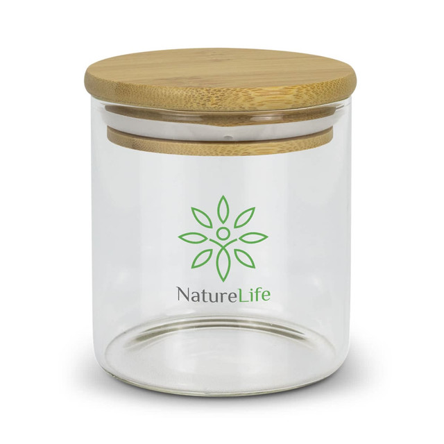 A small round glass storage canister with a bamboo lid and a green logo on the front. A small round glass storage canister with a bamboo lid and a green logo on the front.