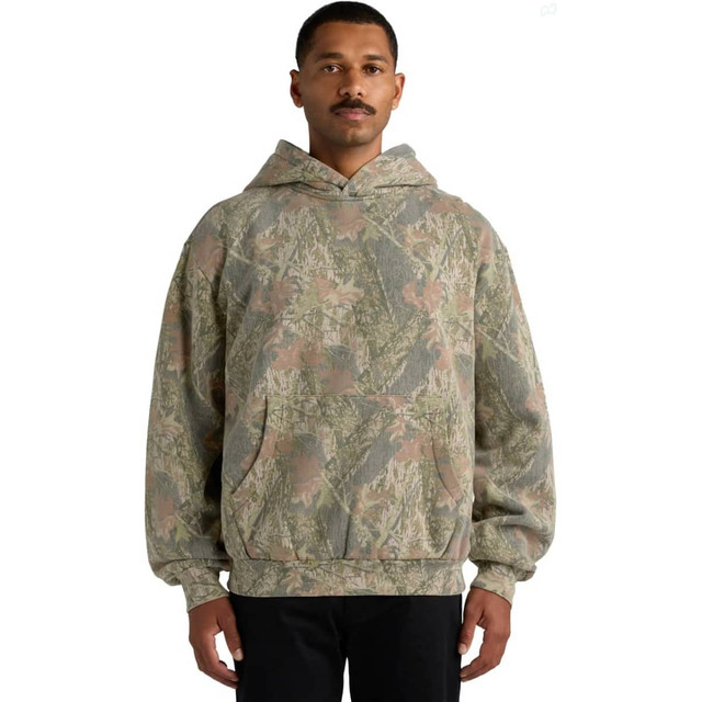 A hooded sweatshirt featuring a faded camouflage pattern in earthy tones. It has a front pocket and a logo.