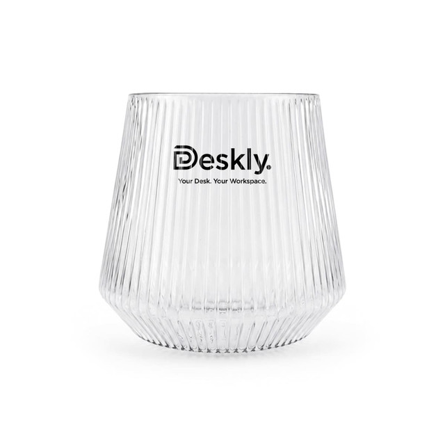 A clear, ribbed glass tumbler with a logo printed on the front.