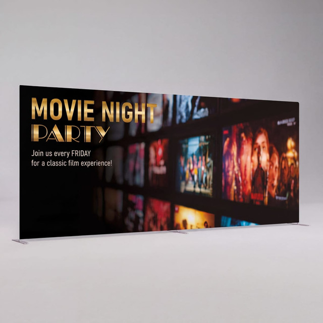 A straight portable display wall with a dark background featuring vibrant movie posters and a logo.