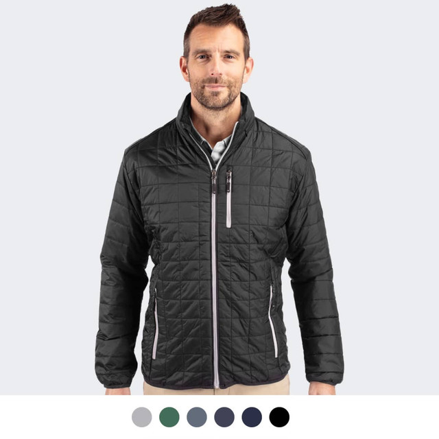 A man wearing a black, quilted Cutter & Buck Rainier jacket with a zipped front and stand-up collar.