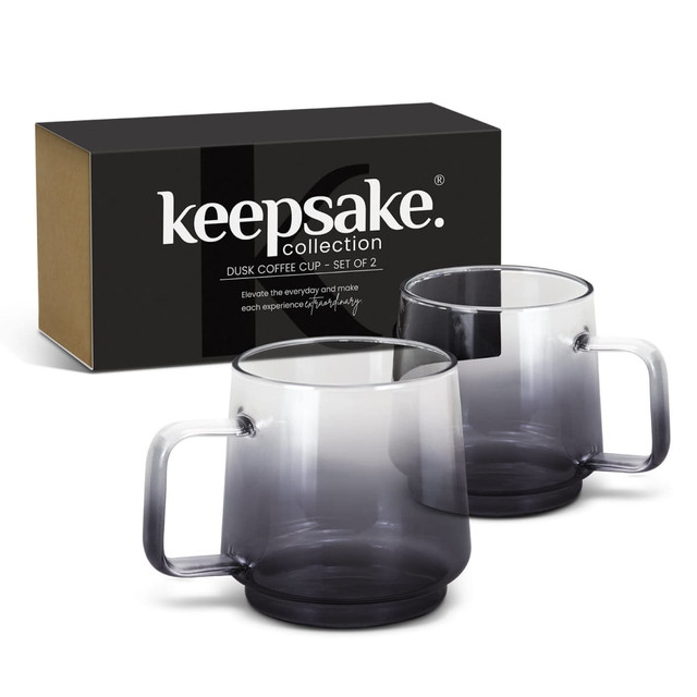 A set of two transparent grey coffee mugs in a black and brown box, featuring smooth handles. A set of two transparent grey coffee mugs in a black and brown box, featuring smooth handles.