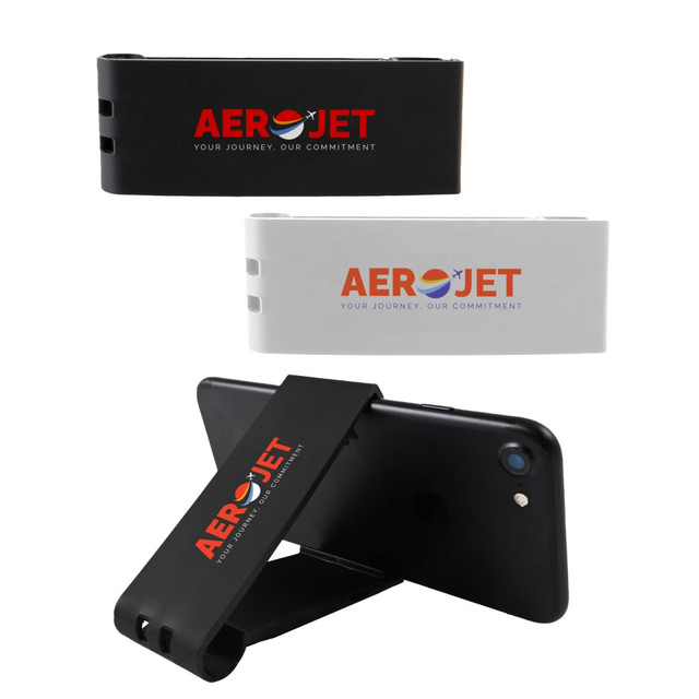 A black and a white Grip Clip Phone Stand are displayed, featuring a logo, holding a smartphone upright. A black and a white Grip Clip Phone Stand are displayed, featuring a logo, holding a smartphone upright.