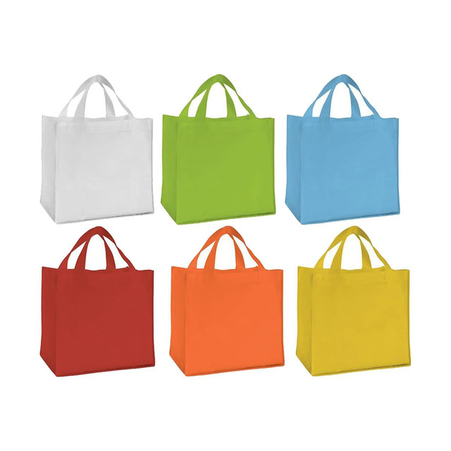 A collection of six non-woven tote bags in white, green, blue, red, orange, and yellow, all with handles and logos.