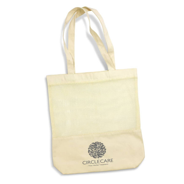 A beige cotton tote bag with a mesh section and long handles, featuring a logo on the front. A beige cotton tote bag with a mesh section and long handles, featuring a logo on the front.