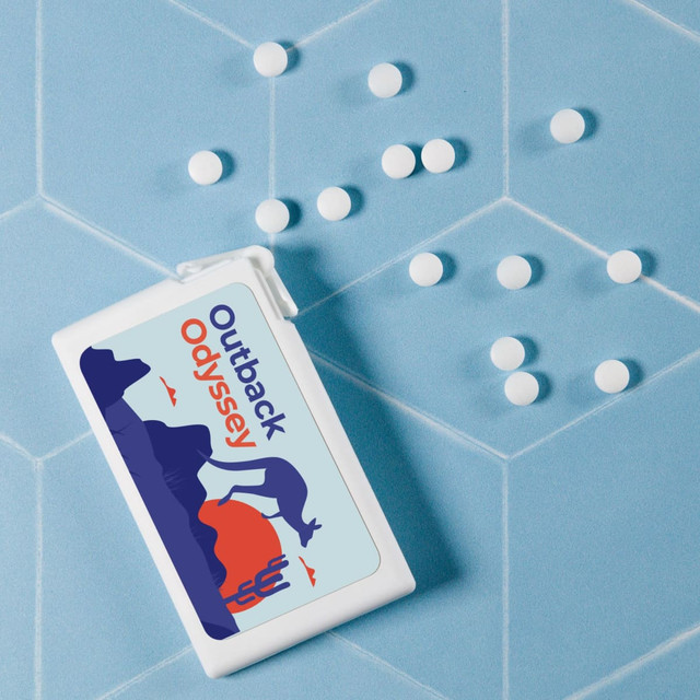 A rectangular container of sugar-free breath mints in white, with white mints scattered on a light blue background. A rectangular container of sugar-free breath mints in white, with white mints scattered on a light blue background.