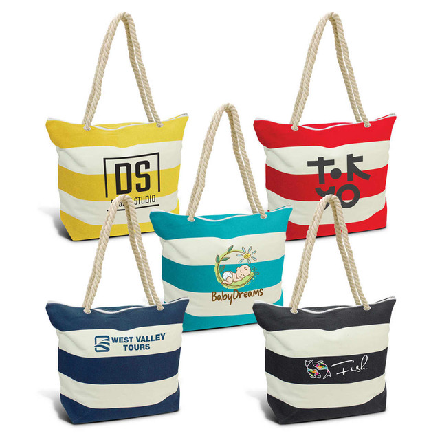 Five striped tote bags in various colours, including yellow, red, blue, and navy, with different logos and rope handles. Five striped tote bags in various colours, including yellow, red, blue, and navy, with different logos and rope handles.