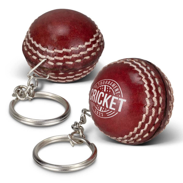 A cricket ball key ring in a rich red colour with white stitching and a metal keyring attachment. A cricket ball key ring in a rich red colour with white stitching and a metal keyring attachment.