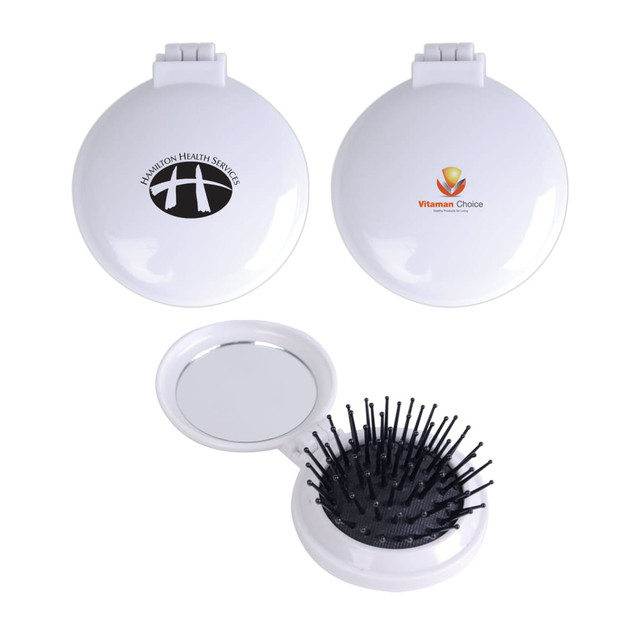 A compact pop-up brush and mirror set in white featuring a logo, with a bristle brush on one side and a mirror inside. A compact pop-up brush and mirror set in white featuring a logo, with a bristle brush on one side and a mirror inside.