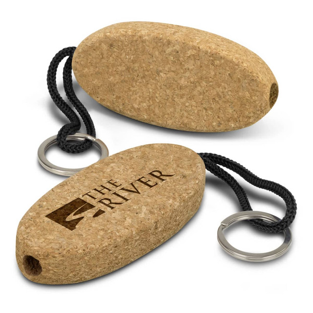 A cork floating key ring in an oval shape with a black cord and metal key ring, featuring a logo. A cork floating key ring in an oval shape with a black cord and metal key ring, featuring a logo.