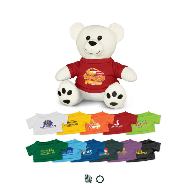 A white plush bear wearing a red shirt, surrounded by other colourful shirts in various shades. The bear has a logo on its shirt.