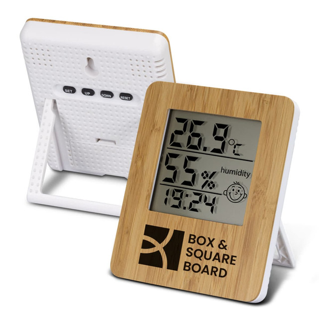 A bamboo weather station with a digital display showing temperature, humidity, and time. It has a white stand and branding. A bamboo weather station with a digital display showing temperature, humidity, and time. It has a white stand and branding.