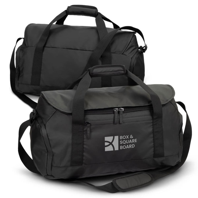 Black duffle bag featuring dual handles, a shoulder strap, and a front zip pocket. Includes branding on one side. Black duffle bag featuring dual handles, a shoulder strap, and a front zip pocket. Includes branding on one side.