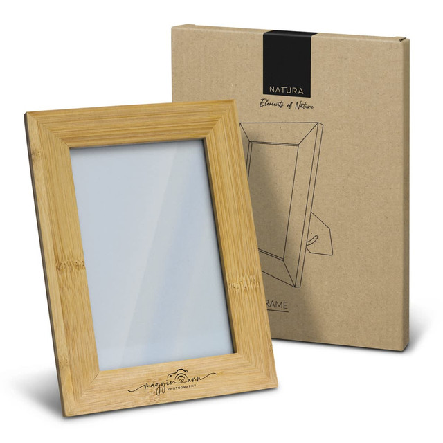 A wooden photo frame in a light bamboo finish, displayed next to its cardboard packaging. A wooden photo frame in a light bamboo finish, displayed next to its cardboard packaging.
