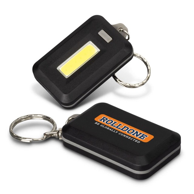 A black key ring light with a COB light and a metal keychain, featuring a logo on one side. A black key ring light with a COB light and a metal keychain, featuring a logo on one side.